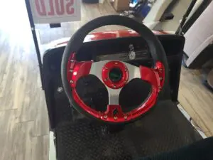A steering wheel with red and black accents.