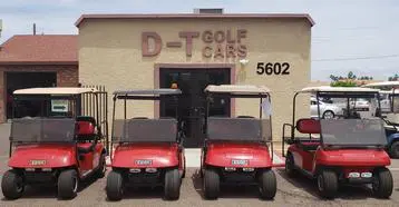 A group of golf carts parked in front of a building.