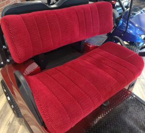 A red seat cover on the back of a truck.