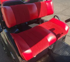 A red seat on the back of an electric vehicle.