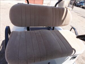 A close up of two seats on a golf cart