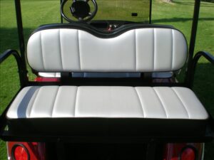 A golf cart seat with the back rest up.