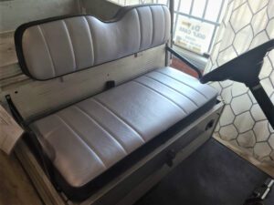 A bench seat with two seats and one seat back.