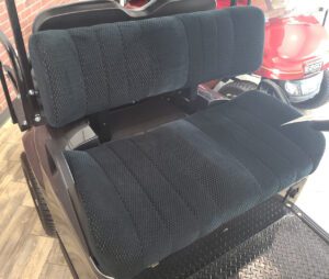 A black bench seat with two rows of seats.