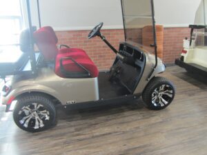 Silver golf cart with red seats in showroom