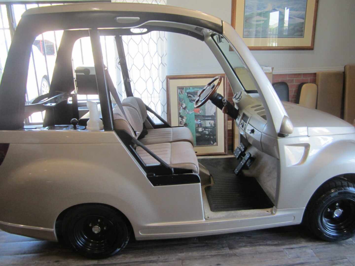 White microcar with two-seat bench interior