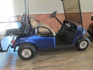 Blue golf cart parked indoors on wooden floor